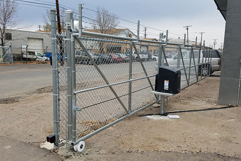 Commercial chain link rolling gate securing an industrial property in Denver
